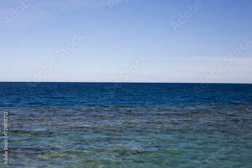 Clear horizon of the red sea. Shimmering blue water in Egypt with clear blue sky. Calm waves with beautiful views of the sea and sky