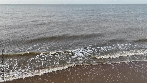 water waves at the shore of the beach drone video