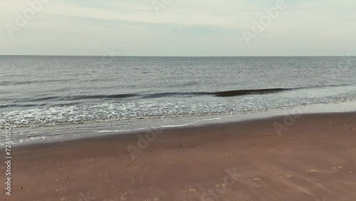water waves at the shore of the beach drone video