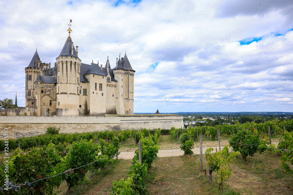 Castle Saumur, France, located at the Loire river under a beautiful sunny cloudscape during daytime.