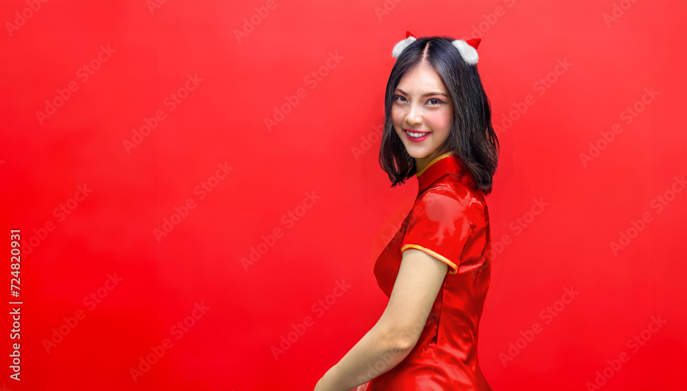 Asian woman in cheongsam clothes portrait on red isolated background with banner size for advertising in Chinese new year festival Asian woman in cheongsam clothes portrait on red isolated background with banner size for advertising in Chinese new year festival