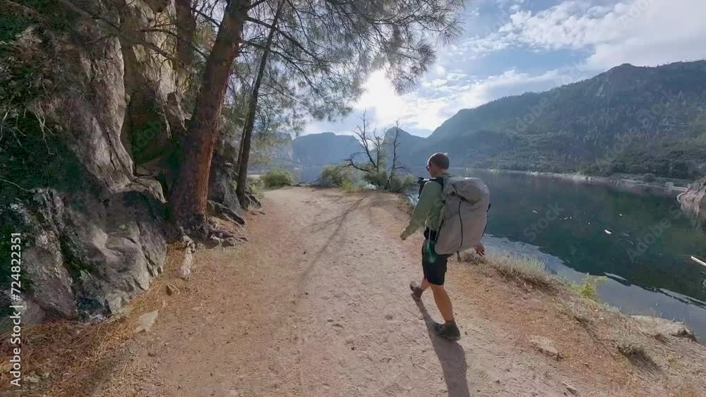 Man Backpacks Along Hetch Hetchy Reservoir in Yosemite