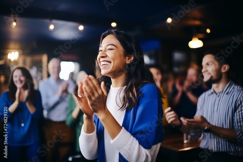 woman receiving applause for karaoke performance in club