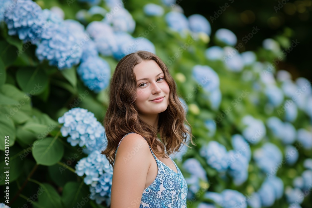 woman in a summer dress against a backdrop of hydrangeas woman in a summer dress against a backdrop of hydrangeas