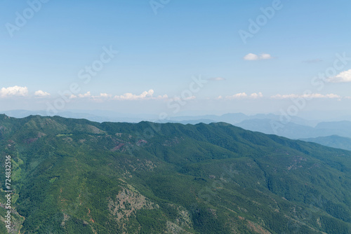 Aerial view of mountains covered with forests in summer © xy