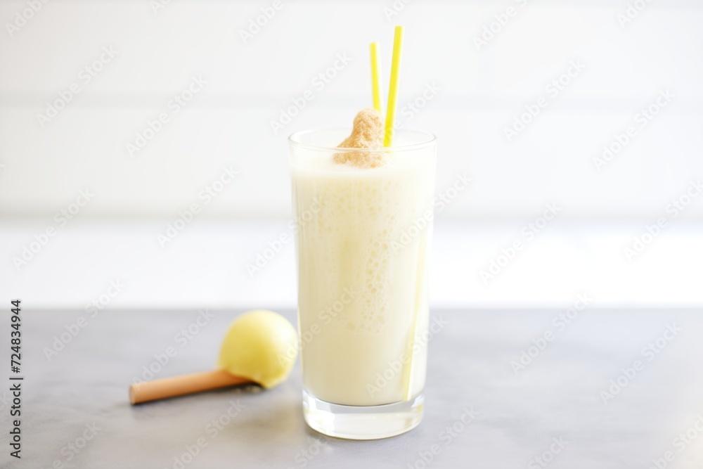 closeup of frothy banana and ginger detox smoothie