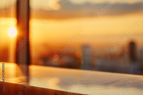 Abstract Blurry Background of The golden sunset view over a city skyline as seen from the vantage point of a high-rise balcony lounge table.