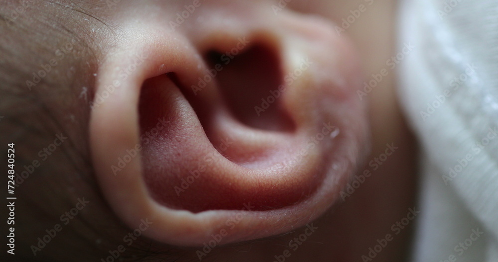 Naklejka premium Newborn macro ear close-up. Infant baby part of the body ear