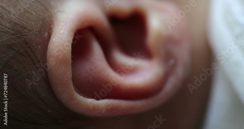 Newborn macro ear close-up. Infant baby part of the body ear