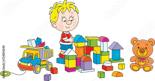 Happy little boy playing with a toy truck and colorful bricks and building a fancy castle in a playroom, vector cartoon illustration on a white background