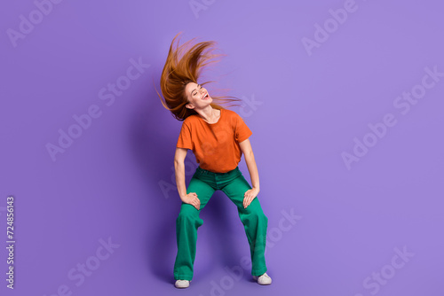 Full length photo of positive lovely nice girl hands touch legs feet turn head listen rock music isolated on purple color background