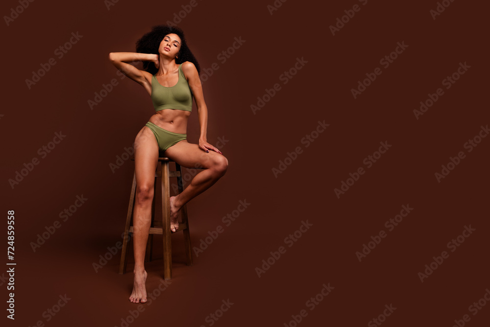 Photo of confident sporty woman athlete ideal perfect strong flawless no filter body empty space isolated over brown color background Photo of confident sporty woman athlete ideal perfect strong flawless no filter body empty space isolated over brown color background