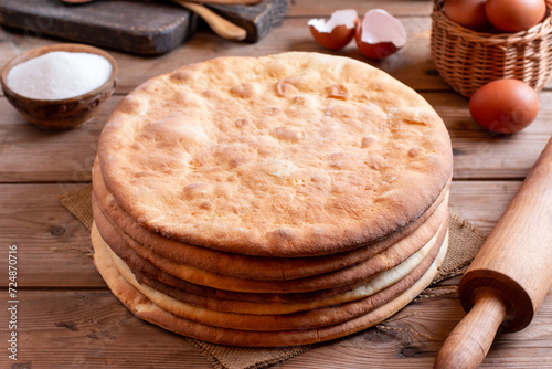 Stacked round baked cake layers on a table. Homemade cooking honey cake.