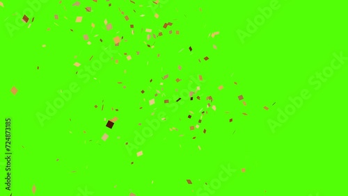 Gold confetti exploding on the sides of the screen in 4K. Confetti falling on a green screen