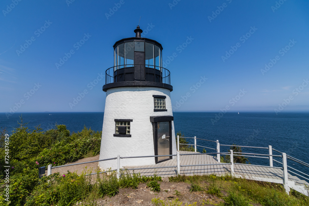 Owls Head Lighthouse in Rockland Maine USA on a clear sunny summer day with blue sky Owls Head Lighthouse in Rockland Maine USA on a clear sunny summer day with blue sky