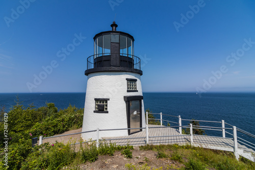 Owls Head Lighthouse in Rockland Maine USA on a clear sunny summer day with blue sky