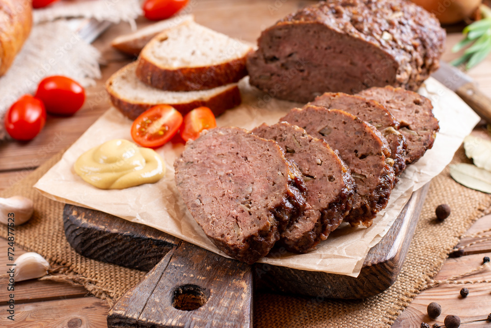 Traditional baked meatloaf slices on wooden table. Sekana Pecene - Czech Meatloaf Traditional baked meatloaf slices on wooden table. Sekana Pecene - Czech Meatloaf