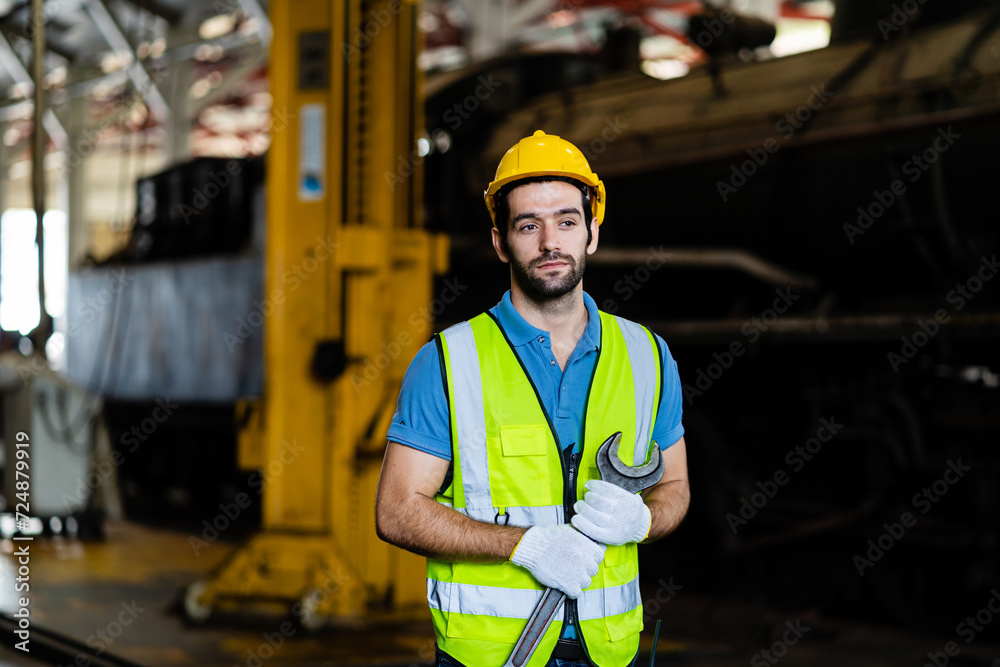 Professional train engineer standing ready to work in train station. Professional railway engineer looking at camera. Professional train engineer standing ready to work in train station. Professional railway engineer looking at camera.