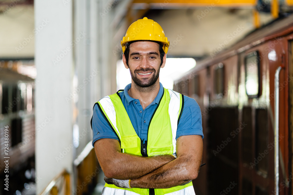 Professional train engineer standing ready to work in train station. Professional railway engineer looking at camera. Professional train engineer standing ready to work in train station. Professional railway engineer looking at camera.