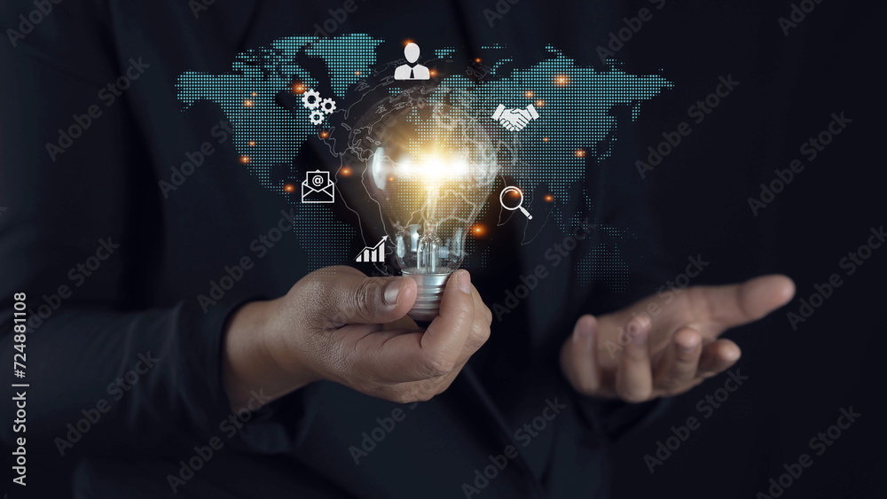 businessman holding light blub with virtual Global Internet connection. global internet connection application technology and digital marketing, Financial and banking, Digital link tech, big data.