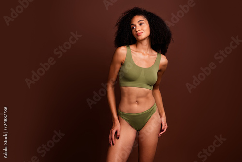 Studio no retouch photo of dreamy adorable lady dressed lingerie looking empty space isolated brown color background © deagreez