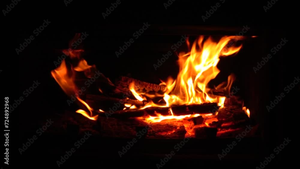 Fire in fireplace burns firewood to heat house. Charred logs burning. Bonfire heat house Fire in fireplace burns firewood to heat house. Charred logs burning. Bonfire heat house