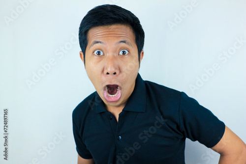 funny expression of shocked and surprised Asian man isolated on white background photo
