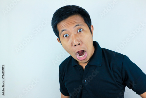 funny expression of shocked and surprised Asian man isolated on white background photo