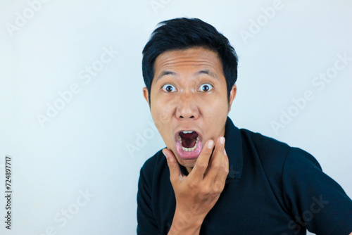 funny expression of shocked and surprised Asian man isolated on white background photo