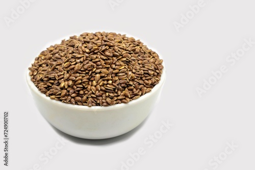 Flaxseed or Linseed in a White Bowl Isolated on White Background with Copy Space, Also Known as Common Flax or Linum Usitatissimum