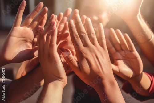 Group of People Raising Hands Together in Celebration at an Event, Team members high-fiving in a close-up shot, with only hands visible and no visible faces, ensuring no hand deformities, AI Generated