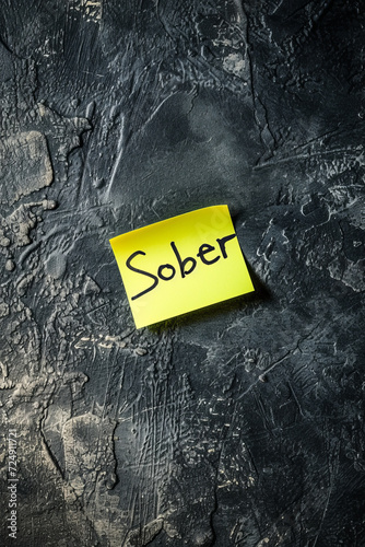 Atmospheric 'Sober' - handwritten post-it note with the word 'Sober' in moody lighting Gen AI photo