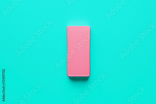 Minimalist illustration of a pink stationery rubber eraser on a teal background