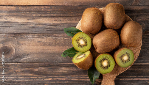 Top view tasty ripe kiwi on wooden background with copy space