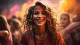 Beautiful woman with colored powder smeared on her face. Smiling girl playing with colors during holi festival at park.