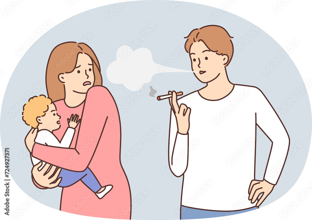 Careless man smoking cigarettes standing next to woman with infant in arms. Shocked girl tries to hide baby from cigarette smoke while walking near smoking passerby