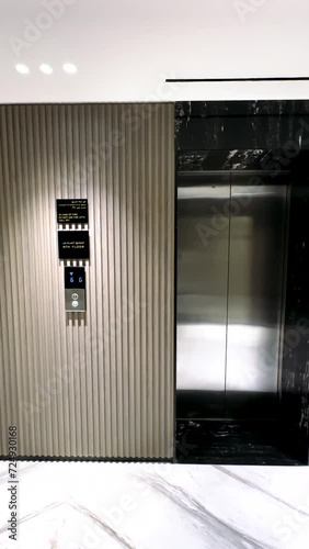 Open elevator door on green screen background.
