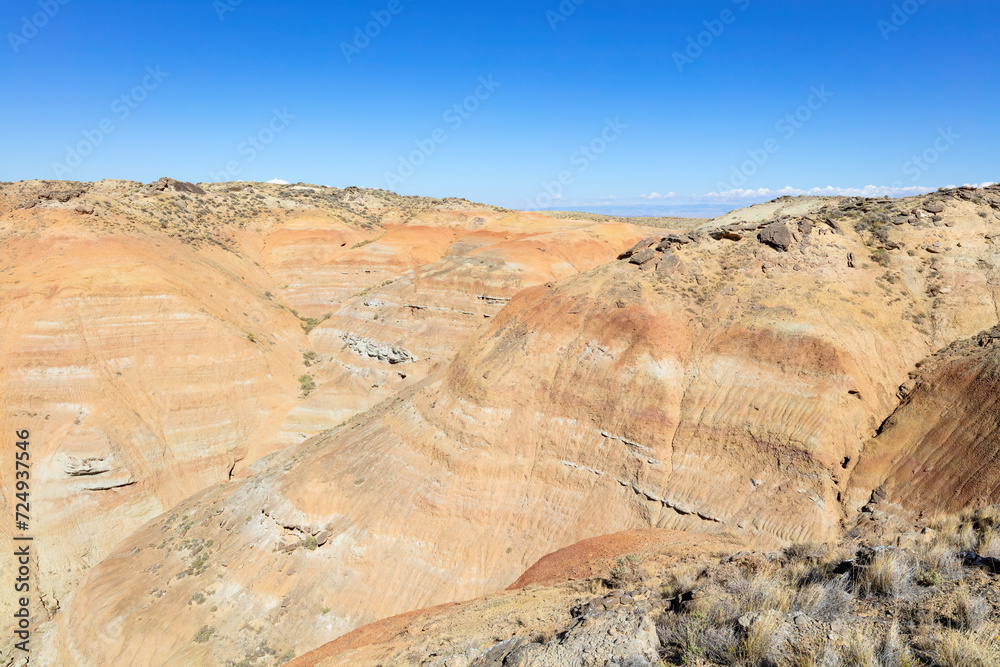 Layered sandstone badlands summer landscape, canyon and blue-sky environment of Wyoming, USA. 
