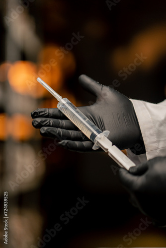 mushroom farm close-up mycologist in gloves holding syringe with mushroom seeds growing natural products photo