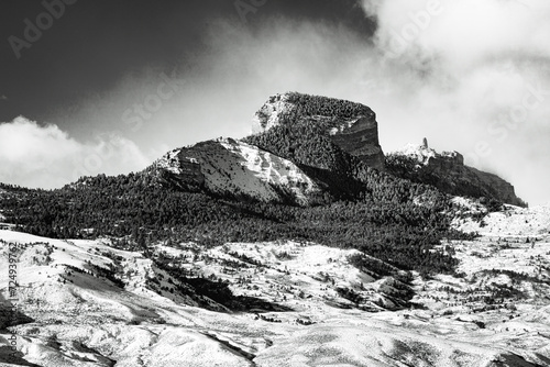 Snow-covered prairie sagebrush and Heart Mountain landscape in northwest Wyoming wilderness, USA. Black and White image.