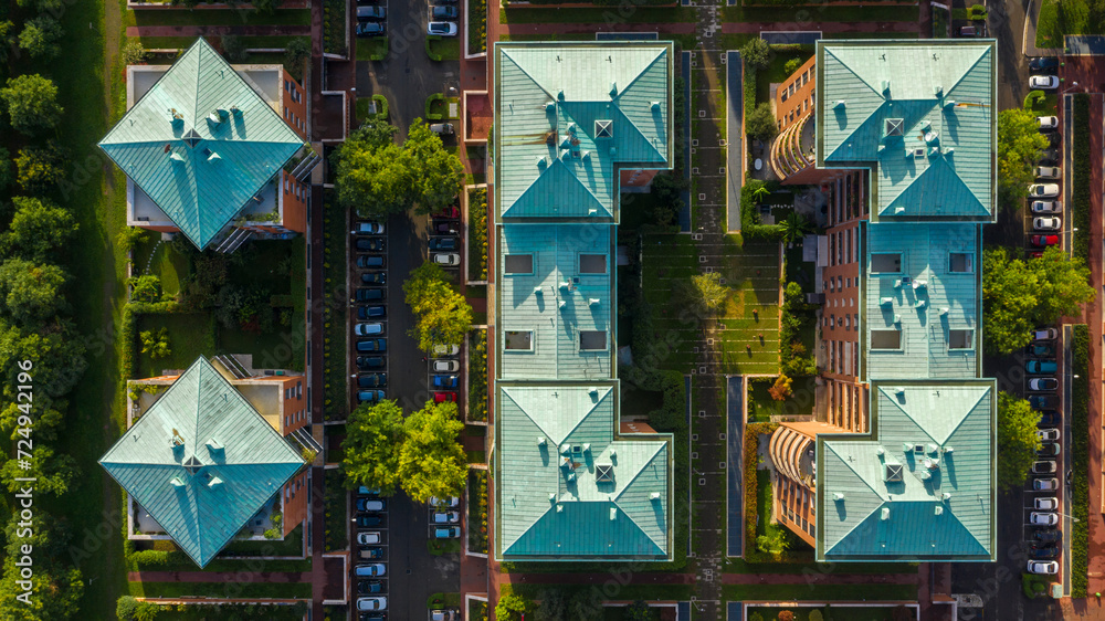 Perpendicular aerial view of the roof of buildings. The roofs have a square rhombus shape.