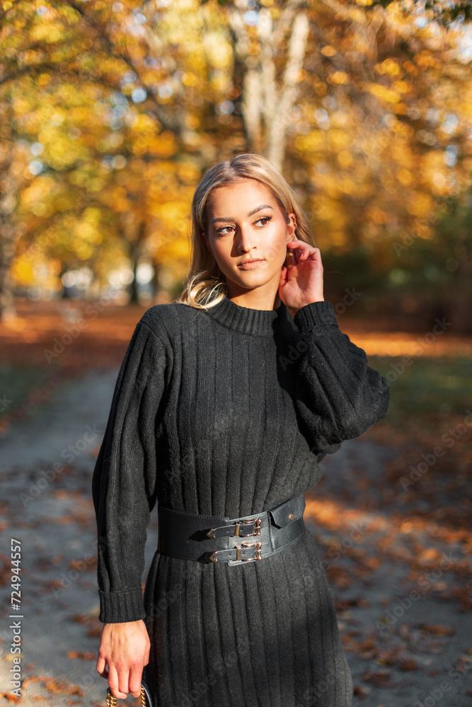 beautiful yellow fresh girl in a fashionable knitted dress walks in a golden park with yellow foliage beautiful yellow fresh girl in a fashionable knitted dress walks in a golden park with yellow foliage