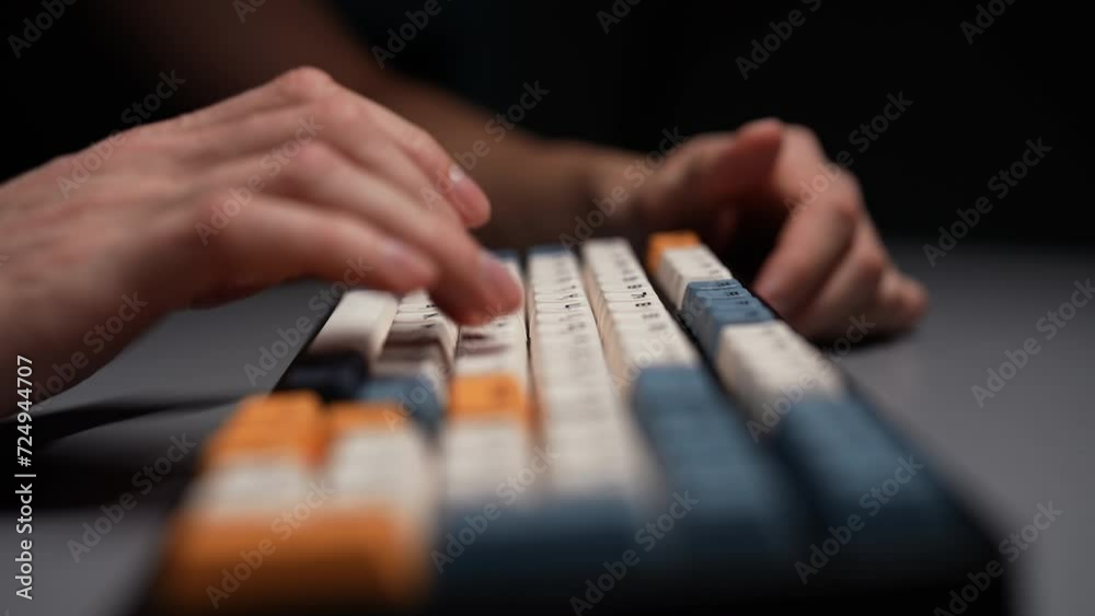 Close-up hands of unrecognizable man typing on wireless mechanical gaming RGB keyboard with stylish colorful keycaps with ASMR thocc sounds, sitting at desk in dark room with cozy light, slow motion. Close-up hands of unrecognizable man typing on wireless mechanical gaming RGB keyboard with stylish colorful keycaps with ASMR thocc sounds, sitting at desk in dark room with cozy light, slow motion.
