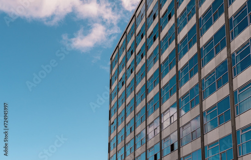 Office building facade under blue sky, on a sunny day