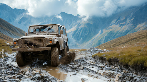 An off-road vehicle tackling rugged terrain in a mountainous area.