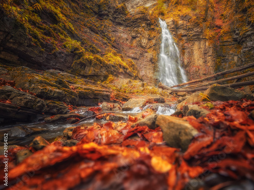 view to waterfall in canyon in fall season and red colours