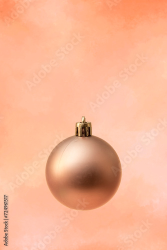 golden christmas ball on an orange background