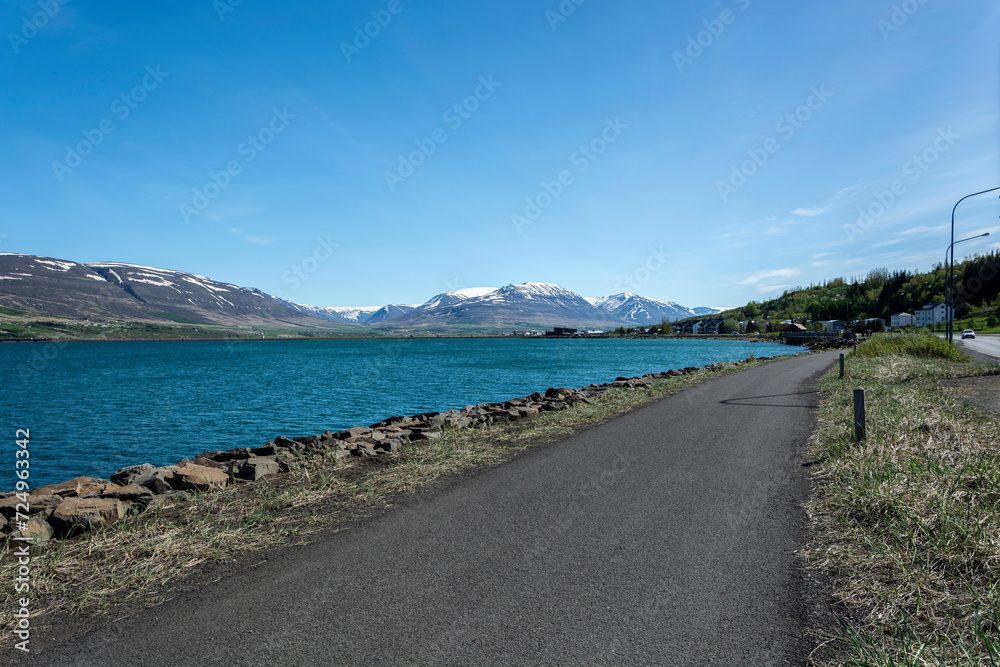 Road along the shore of a lake in the Norwegian fjord Road along the shore of a lake in the Norwegian fjord