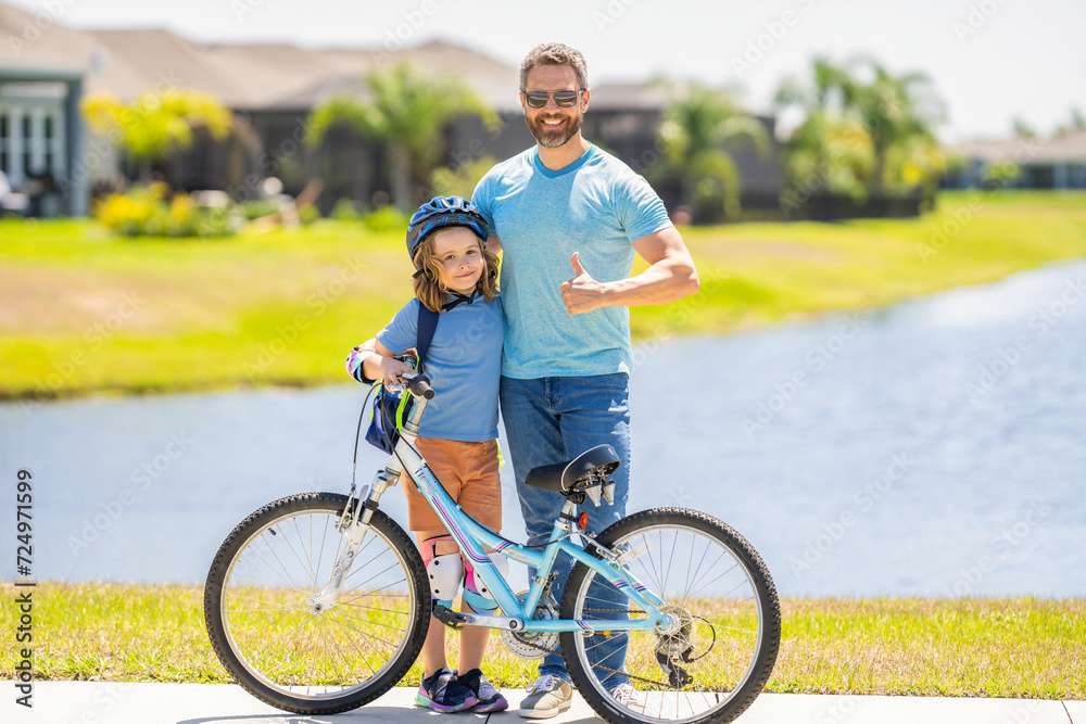 Fototapeta premium father and son in fatherhood. fatherhood of father and son cycling at sunlit park. father and son navigate the winding paths together. Fatherhood on wheels. father and son promenade