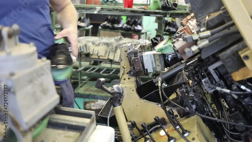 Worker works on machine in Ralf Ringer factory, slow motion photo